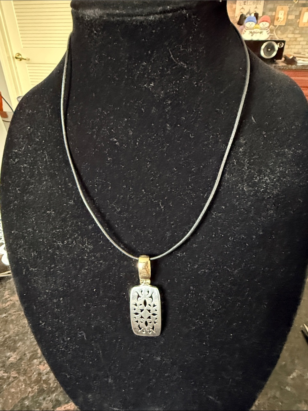 Premier Design vintage two-toned signed pendant on corded necklace.